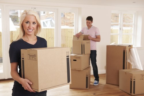Two movers coordinating a careful lift of furniture